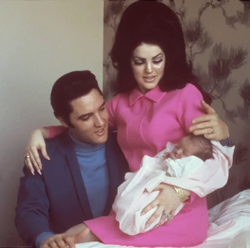 Priscilla Presley and Elvis Presley holding their daughter Lisa Marie Presley in 1968