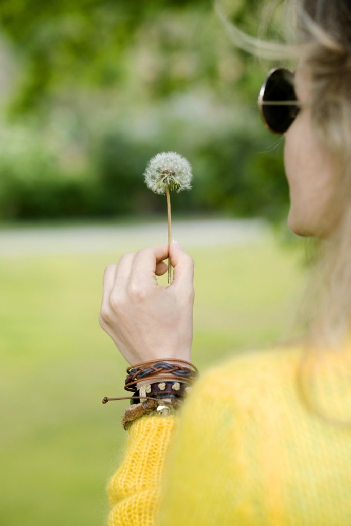 Girl holding dandelion