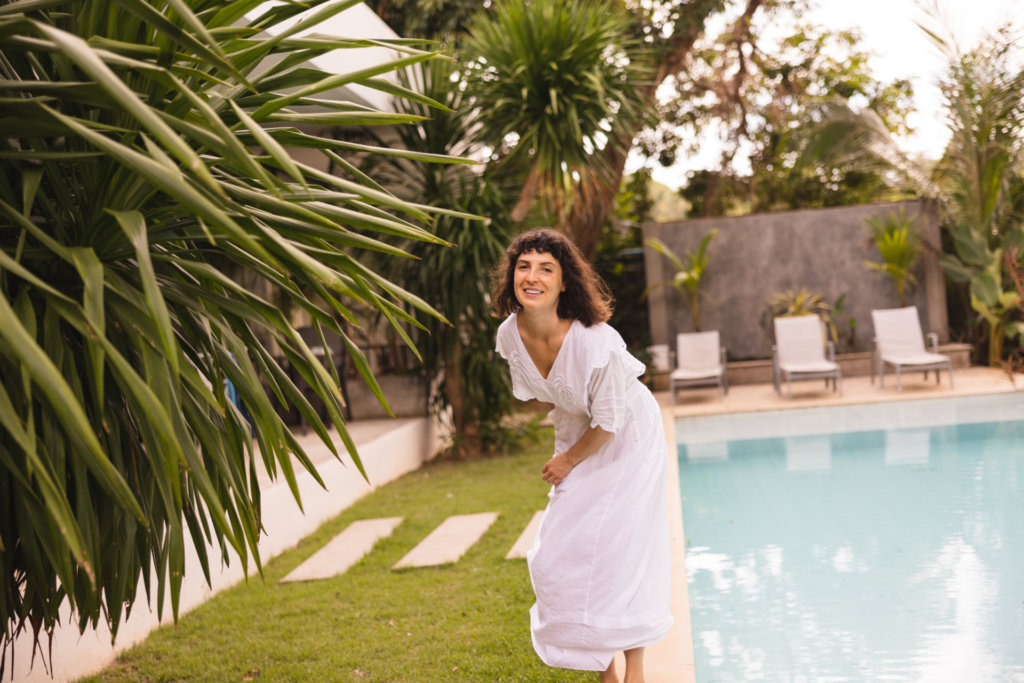 funny young woman spends time vacation by pool outdoors