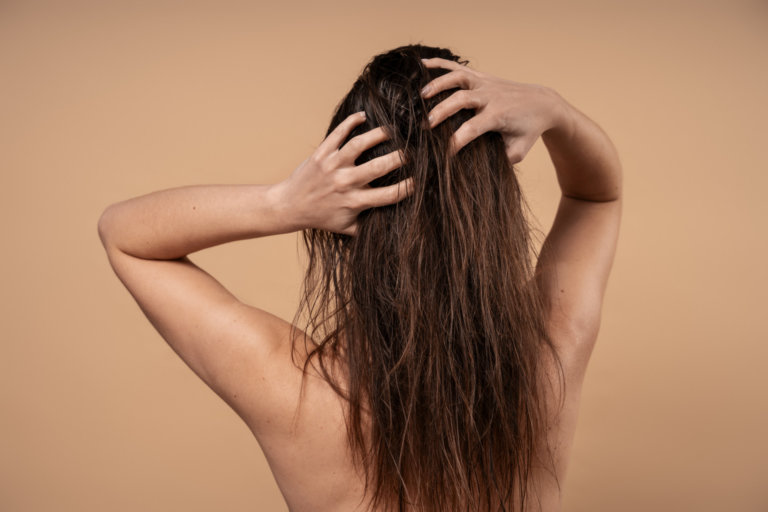 woman giving herself scalp massage