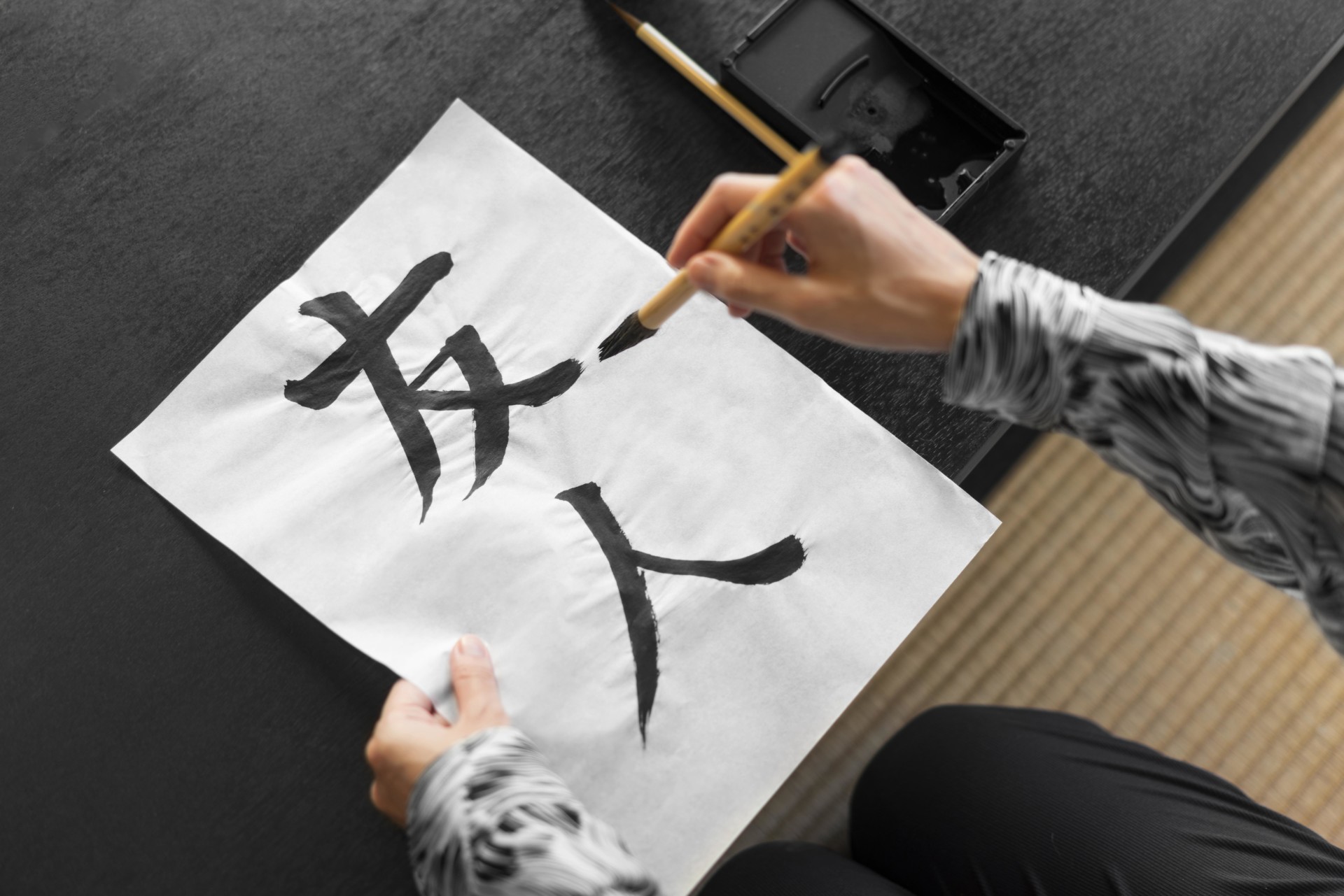 A Man Writing Chinese Characters