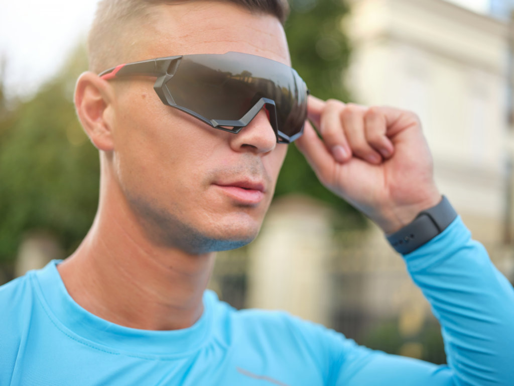 male cyclist putting protective glasses